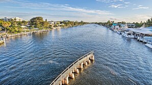 A waterfront hotel with a dock, boats, and a clear view of the water. - 1 Block to Deerfield Beach: Studio w/ Fire Pit! (Deerfield Beach)