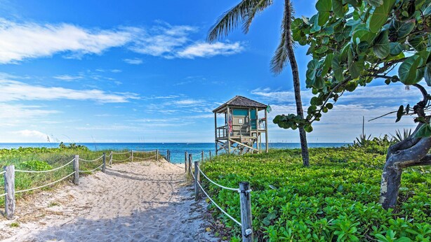 A beach pathway leading to a lifeguard tower with a view of the ocean. - 1 Block to Deerfield Beach: Studio w/ Fire Pit! (Deerfield Beach)