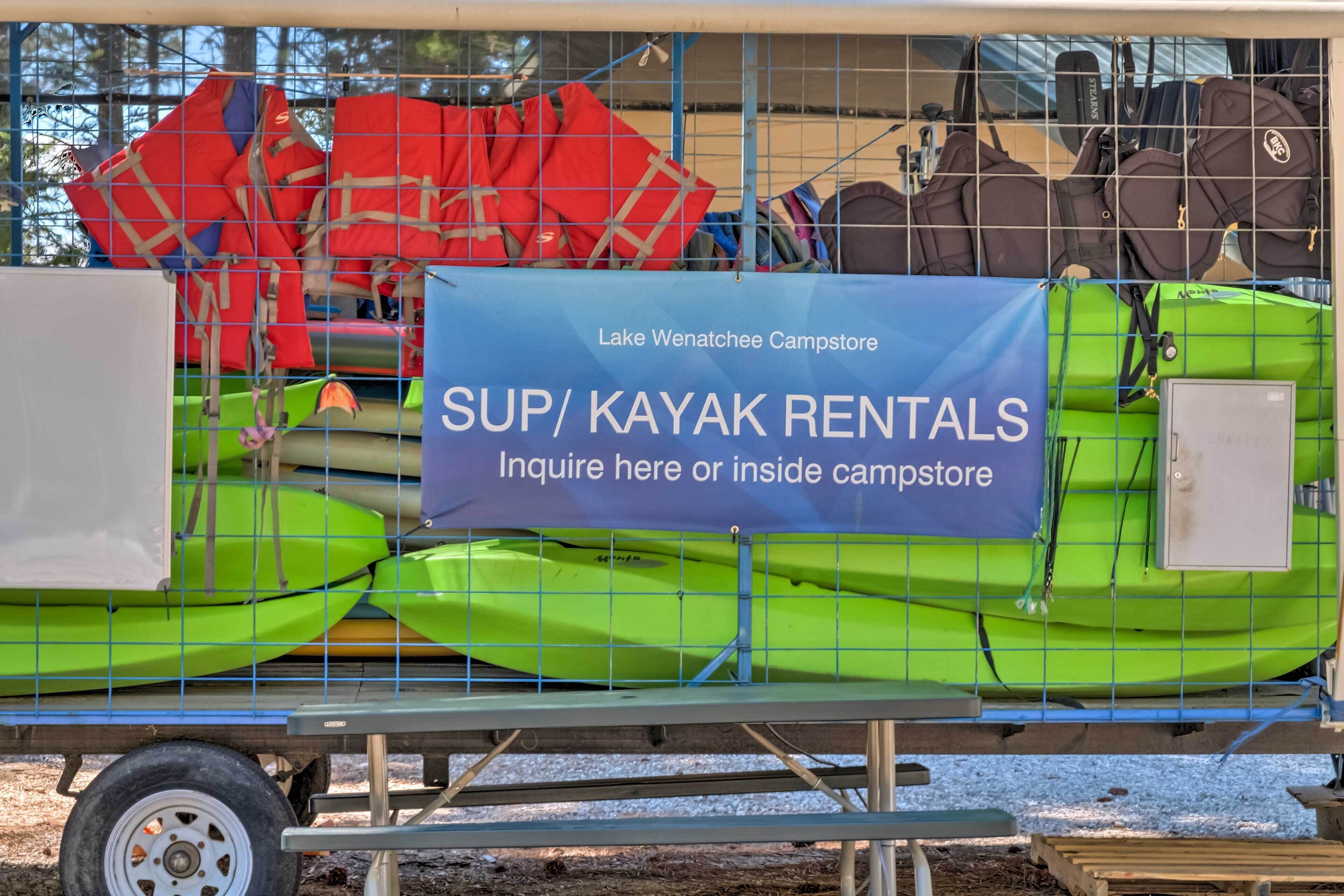 A storage area with kayaks and life jackets, a sign for SUP/KAYAK RENTALS, and a Lake Wenatchee Campstore sign.