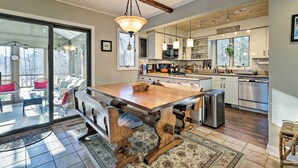 A spacious kitchen with a wooden island, stainless steel appliances, and a large window. - Peaceful Goshen Cottage w/ Screened Porch & Views! (Goshen)
