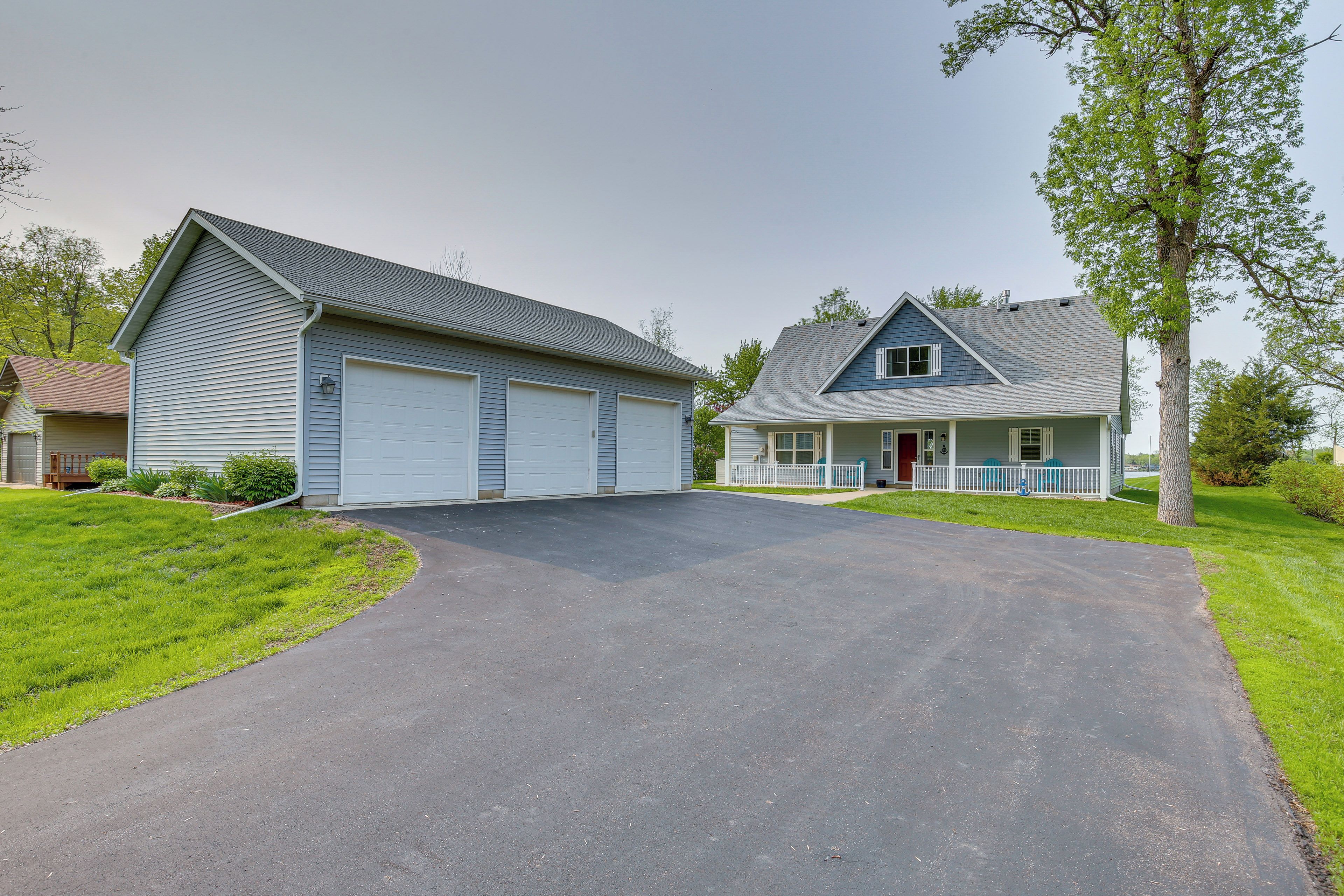 A two-story house with a garage and a front porch.