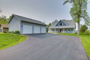 A two-story house with a garage and a front porch. - Stunning Waterville Home on Tetonka Lake! (Waterville)