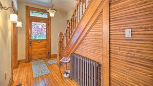 A wooden staircase with a radiator and a door with a stained glass window. - Front Royal Retreat ~ 1 Mi to National Park! (Front Royal)