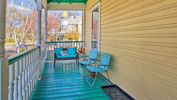 A porch with a green roof, a wicker sofa with blue cushions, and two blue chairs. - Front Royal Retreat ~ 1 Mi to National Park! (Front Royal)