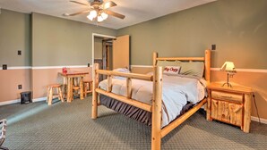 A room with a wooden bed, a small table, a nightstand, and a ceiling fan. - 'wildlife Lodge' Columbia Retreat off I-70! (Fulton)