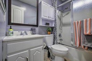 A bathroom with a white sink, a toilet, a shower, and a mirror. - Relaxing Poway Apt w/ Patio Near Parks & Wineries! (Poway)