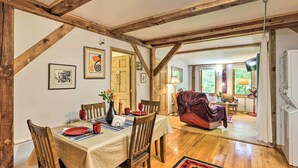 A dining area with a wooden table set for four, wooden chairs, and a red and black patterned rug. - Cookout Ready! 'sweet Suite' w/ Views in Leicester (Marshall)