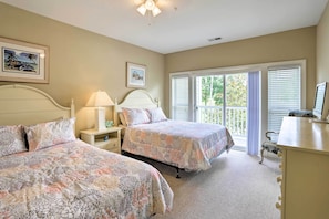 A bedroom with two beds, a nightstand, a dresser, and a window with blinds. - Relax by Pool & Golf: Chic Myrtle Beach Condo (Myrtle Beach)