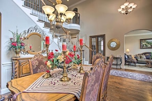 A dining area with a wooden table, ornate chairs, and a chandelier. - 4 Mi to Grapevine Lake: Texas Home w/ Media Room (Flower Mound)