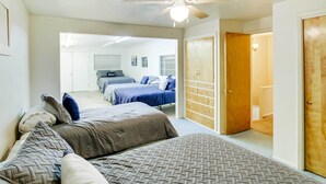 A bedroom with two beds, a wardrobe, and a ceiling fan. - Main Street Townhome - 12 Miles to Bear Lake! (Paris)