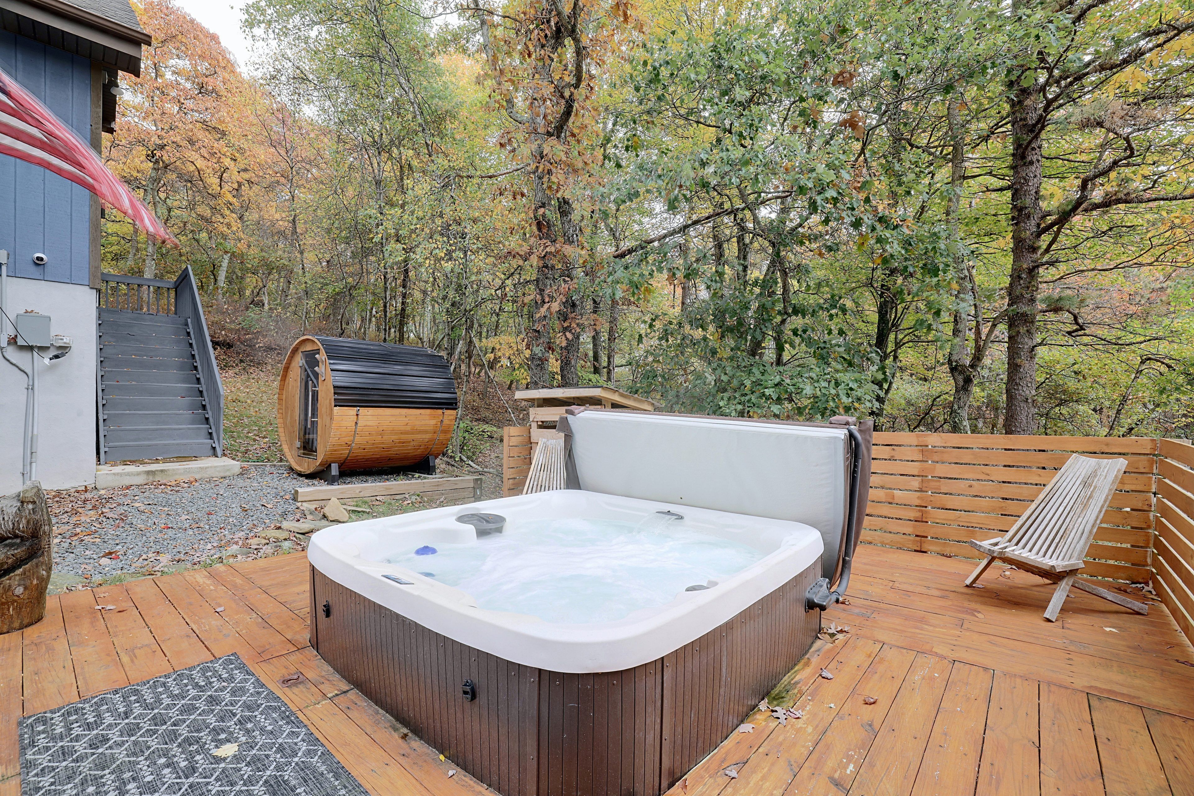 A hot tub on a wooden deck with a view of a forested area.