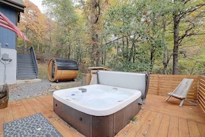 A hot tub on a wooden deck with a view of a forested area. - Hot Tub, Fire Pit & Barrel Sauna: Poconos Abode (Long Pond)