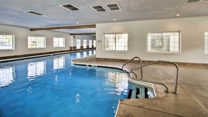 An indoor swimming pool with clear water, a diving board, and windows along the walls. - Stunning Table Rock Lake Condo Near Branson Strip! (Branson)