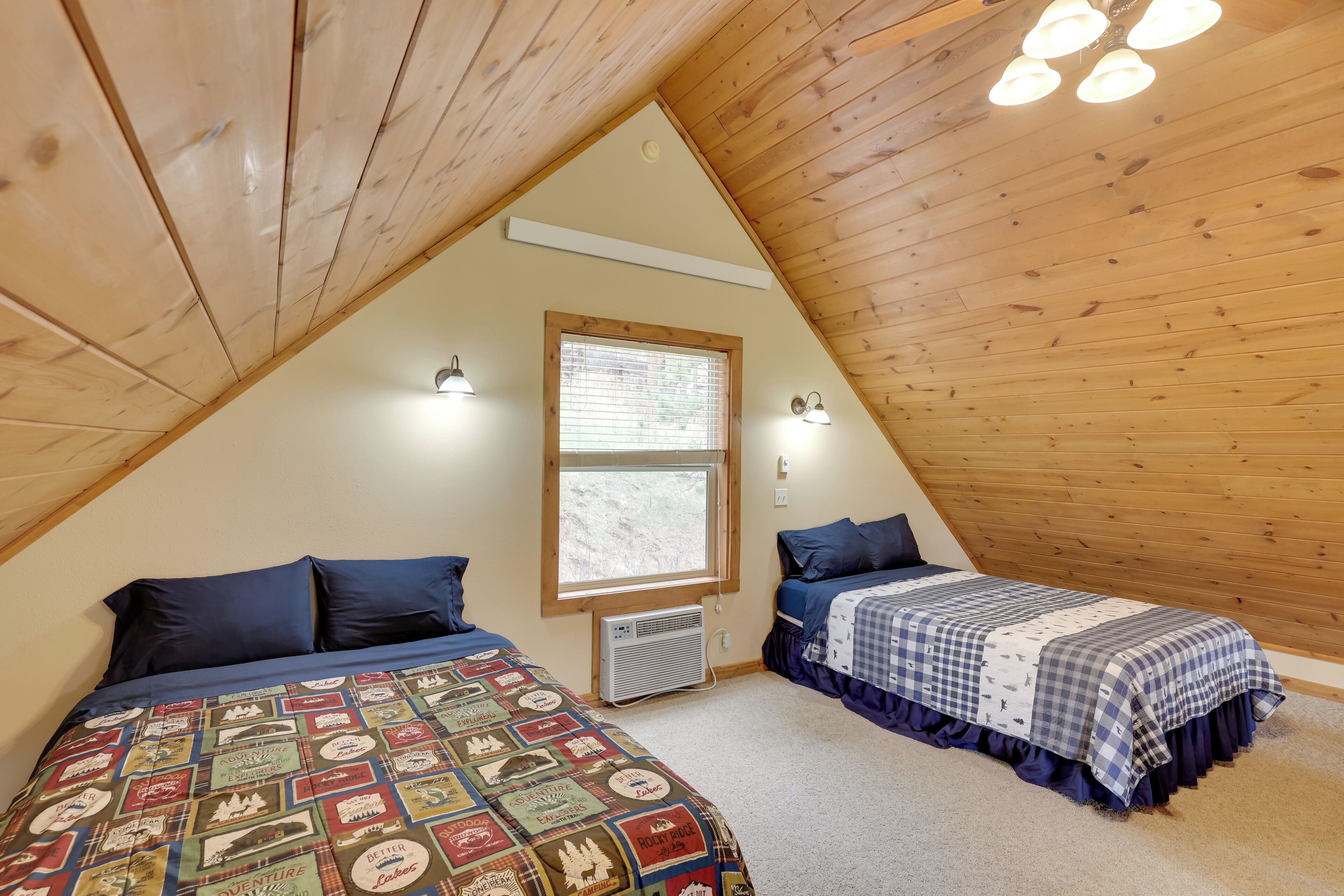 A bedroom with two beds, a window, and wooden ceiling beams.