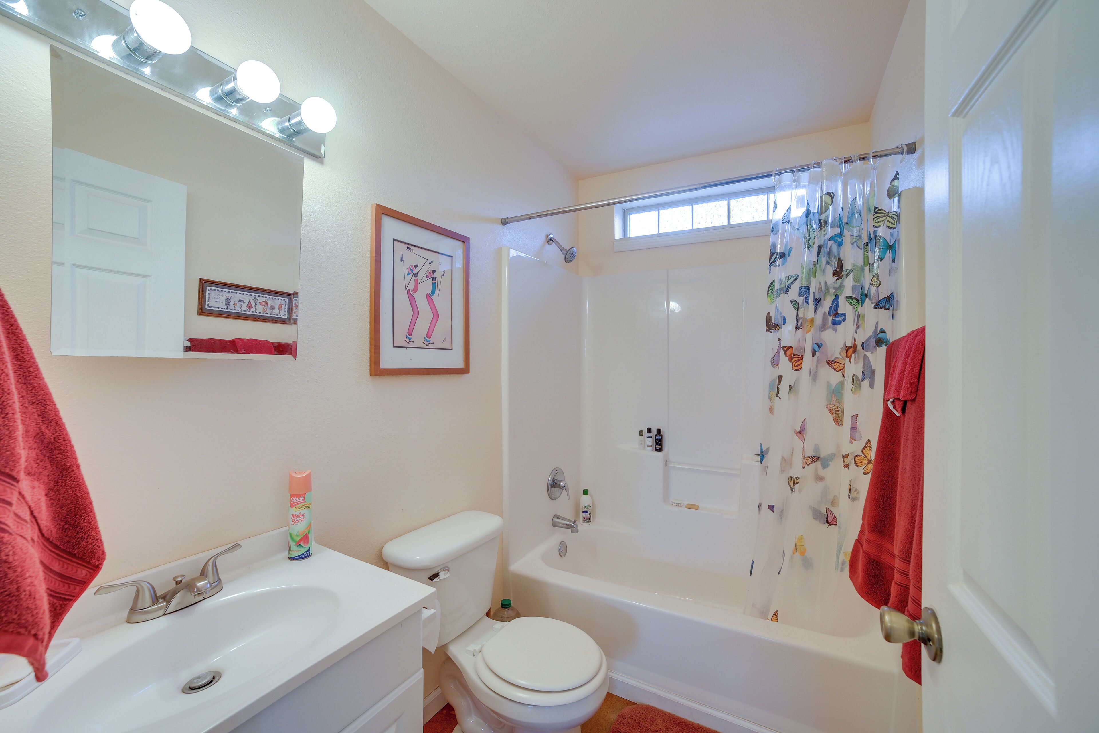 A bathroom with a sink, toilet, and bathtub.