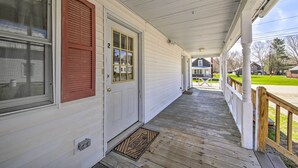 A covered porch with a white exterior, a red door, and a welcome mat. - Cozy Bingham Apt, 1 Mi to Rafting & ATV Trail (Bingham)