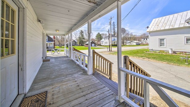 A wooden porch with a white railing, a clear view of the street, and a well-maintained lawn. - Cozy Bingham Apt, 1 Mi to Rafting & ATV Trail (Bingham)