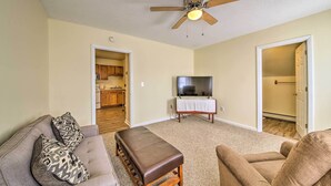 A living room with a sofa, ottoman, and a ceiling fan. - Cozy Bingham Apt, 1 Mi to Rafting & ATV Trail (Bingham)