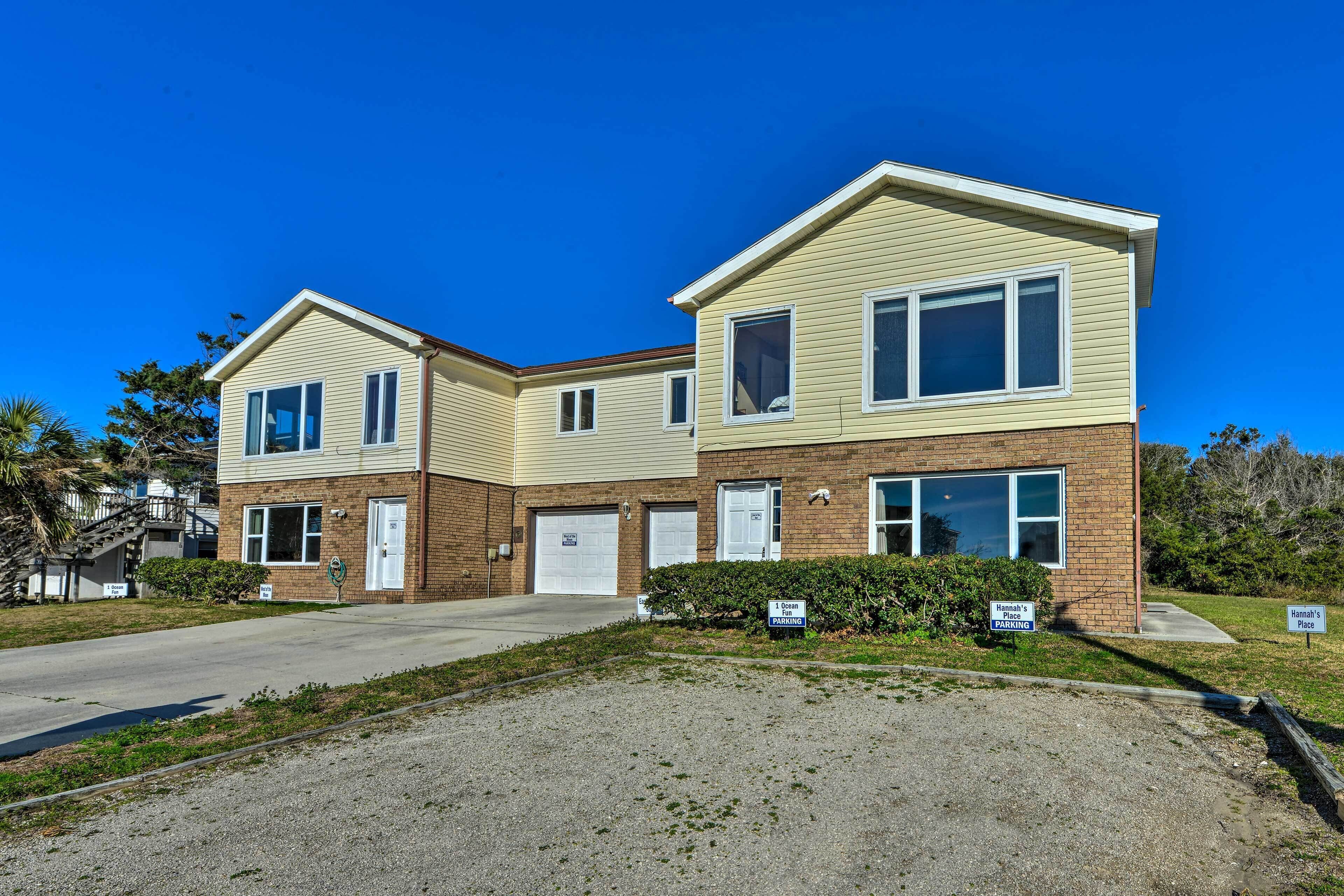 A two-story building with a garage and a driveway.