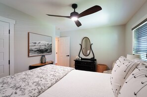 A bedroom with a bed, a dresser, a mirror, a ceiling fan, and a window with blinds. - Walk to Beach: Lake Michigan Getaway! (Muskegon)