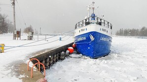 A blue ship named 'LAUREN' docked at a pier with snow on the ground. - Walk to Beach: Lake Michigan Getaway! (Muskegon)