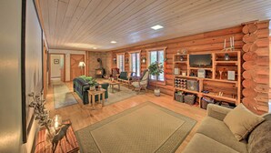 A cozy log cabin interior with a living room, fireplace, and wooden shelves. - Riverfront Troy Cabin Ready With Bikes & Rafts! (Troy)