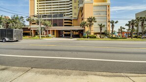 A hotel with a modern design, featuring a multi-story structure with a prominent entrance and a parking area in front. - Myrtle Beach Condo w/ Lazy River: Walk to Beach! (Myrtle Beach)