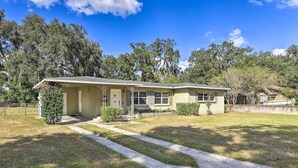 A single-story house with a front porch, a small front yard, and a clear sky. - Lakeland Home w/ Large Backyard ~ 1 Mile From Fsc! (Lakeland)