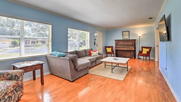 A living room with a gray sofa, a coffee table, and a piano. - Lakeland Home w/ Large Backyard ~ 1 Mile From Fsc! (Lakeland)