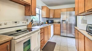 A kitchen with wooden cabinets, stainless steel appliances, a microwave, and a toaster. - Lakeland Home w/ Large Backyard ~ 1 Mile From Fsc! (Lakeland)