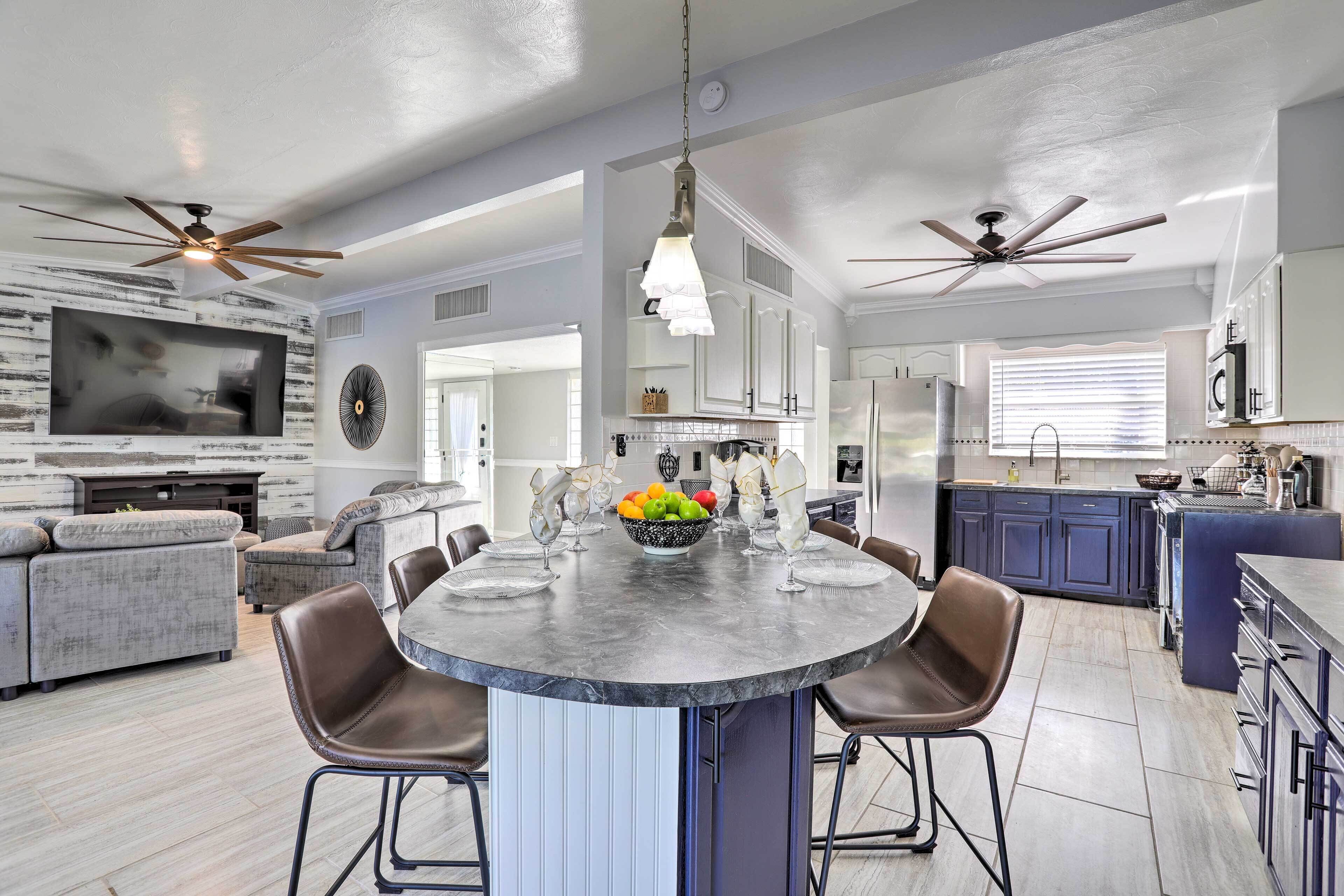 A spacious kitchen with a central island, modern appliances, and a dining area.