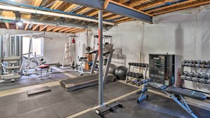 A gym with exercise equipment, a treadmill, and a bench. - Pet-friendly Parker House Rental w/ Home Gym! (Parker)