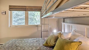 A bunk bed with a ladder, a window with blinds, and a bed with patterned bedding. - Peaceful Edwards Condo w/ Mountain Views! (Edwards)