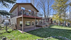 A two-story house with a balcony, a covered porch, and a fenced yard. - Cozy Carbondale Escape w/ Deck & Grill! (Carbondale)