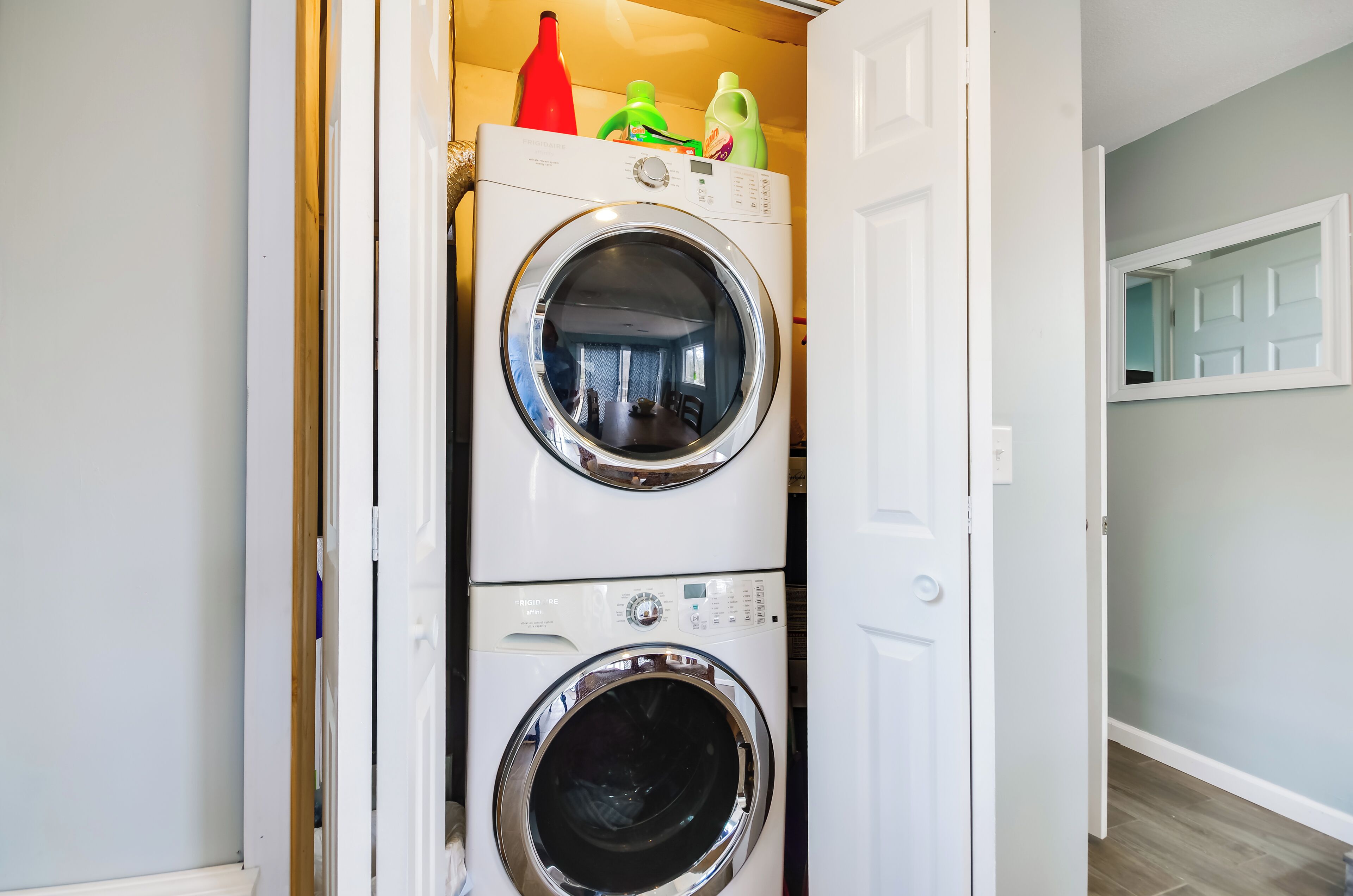 A laundry room with two stacked front-loading washing machines.