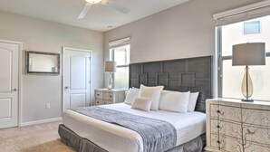 A bedroom with a bed, a ceiling fan, a dresser, and a window with blinds. - Kissimmee Retreat With Private Pool & Spa (Kissimmee)