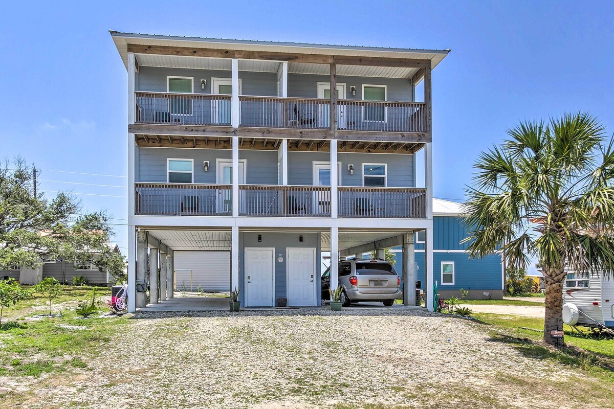 A multi-story building with a covered parking area and a vehicle parked inside.