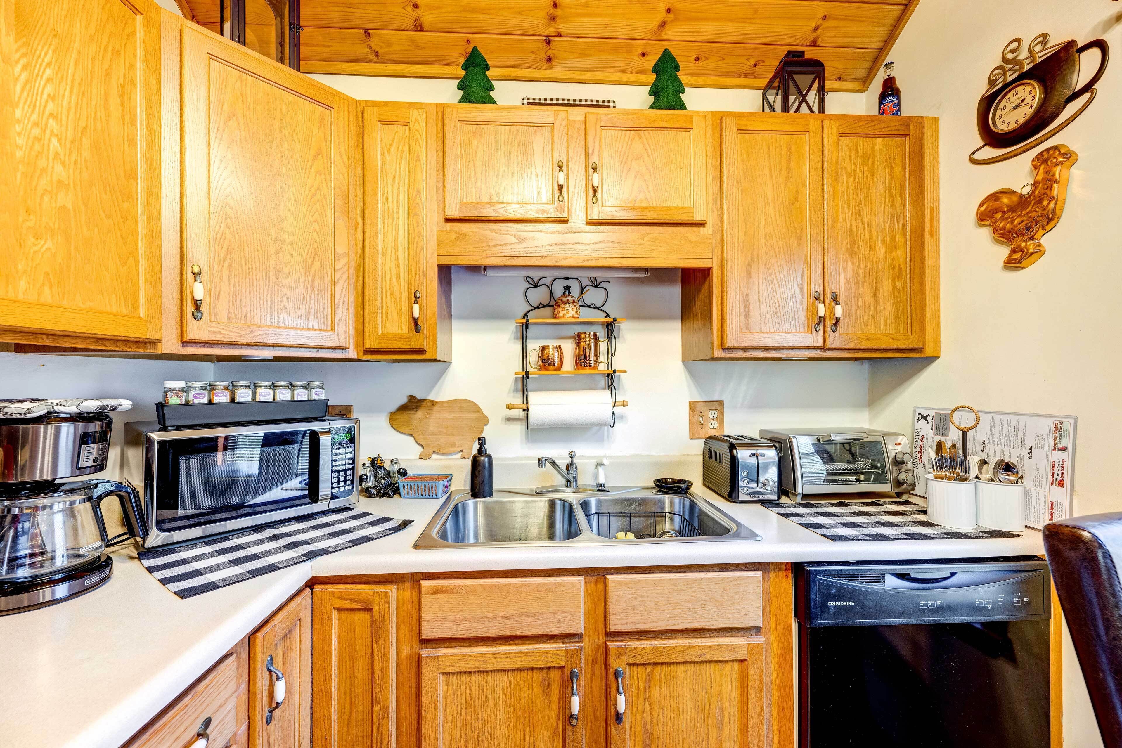 A kitchen with wooden cabinets, a microwave, a coffee maker, a dishwasher, and a sink.