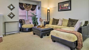 A living room with a sofa, two armchairs, a coffee table, and a floor lamp. - Maryland Vacation Rental Near Baltimore (Perry Hall)