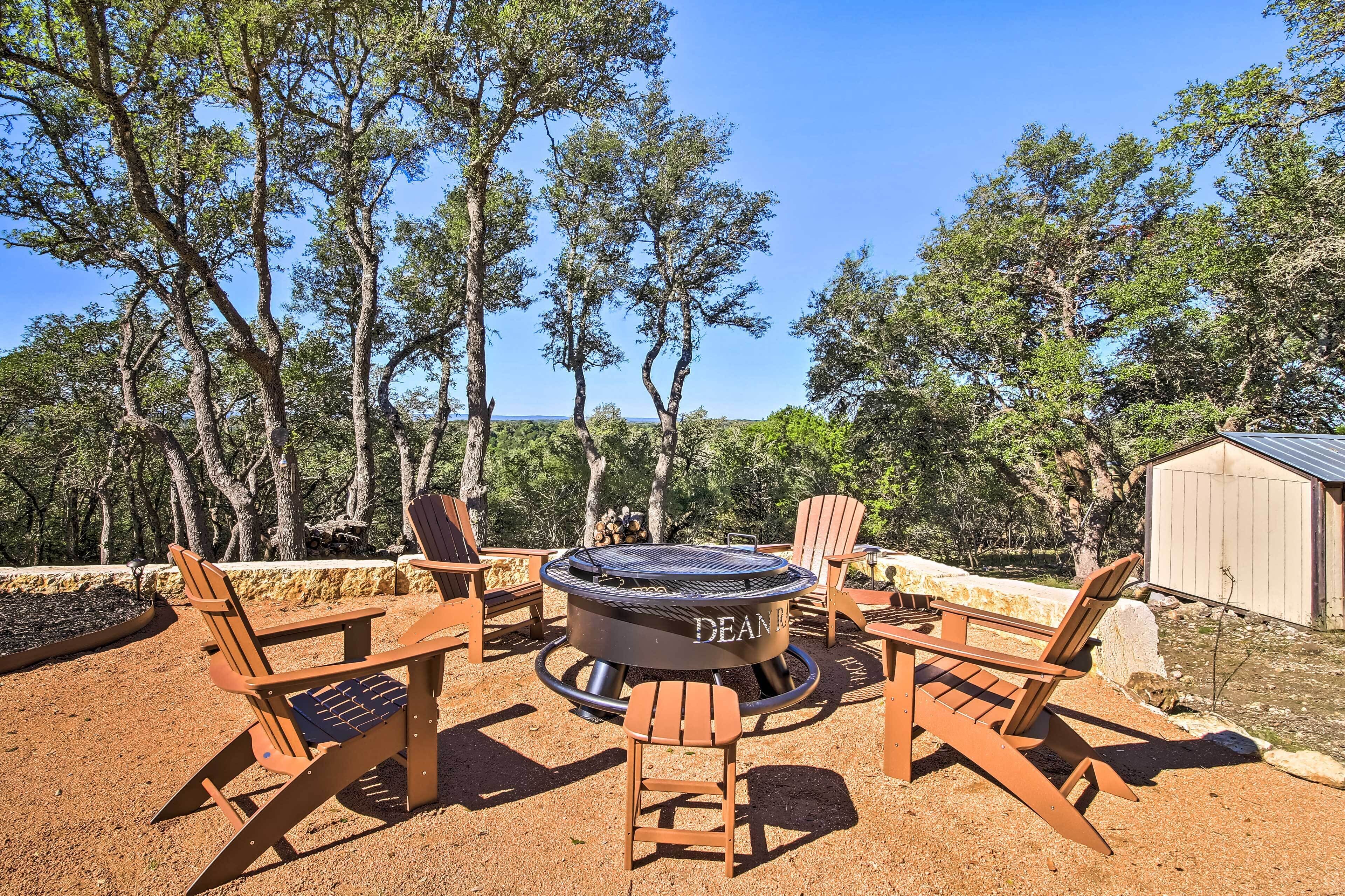 An outdoor seating area with Adirondack chairs and a circular fire pit labeled "DEAN."