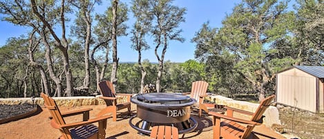 An outdoor seating area with Adirondack chairs and a circular fire pit labeled "DEAN."