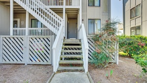 A multi-story residential building with a central staircase leading to the entrance. - Harbor Island Condo With Deck - Steps to Beach! (Harbor Island)