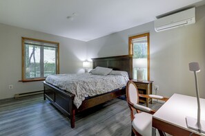 A bedroom with a bed, bedside tables, a desk, and a chair. - Hot Tub + Game Room: Peaceful Poconos Home! (Lake Harmony)