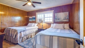 A room with two beds, wooden walls, a ceiling fan, and a window with blinds. - Pet-friendly Cabin With Designated Boat Slip! (Higden)