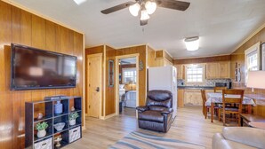 A spacious living room with a flat-screen TV, a leather recliner, and a patterned rug. - Pet-friendly Cabin With Designated Boat Slip! (Higden)