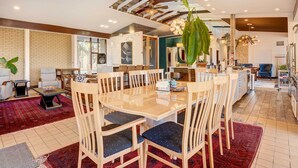 A spacious living area with a large round table, multiple chairs, and a red carpet. - Stylish + Serene West Friendship Hidden Gem! (West Friendship)