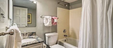A bathroom with a sink, toilet, and bathtub.