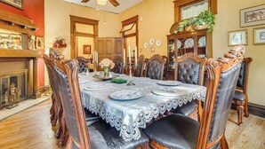 A dining room with a large table set for six, surrounded by ornate chairs. - Creekfront Yellville Manor w/ Parlors & Fire Pit! (Yellville)