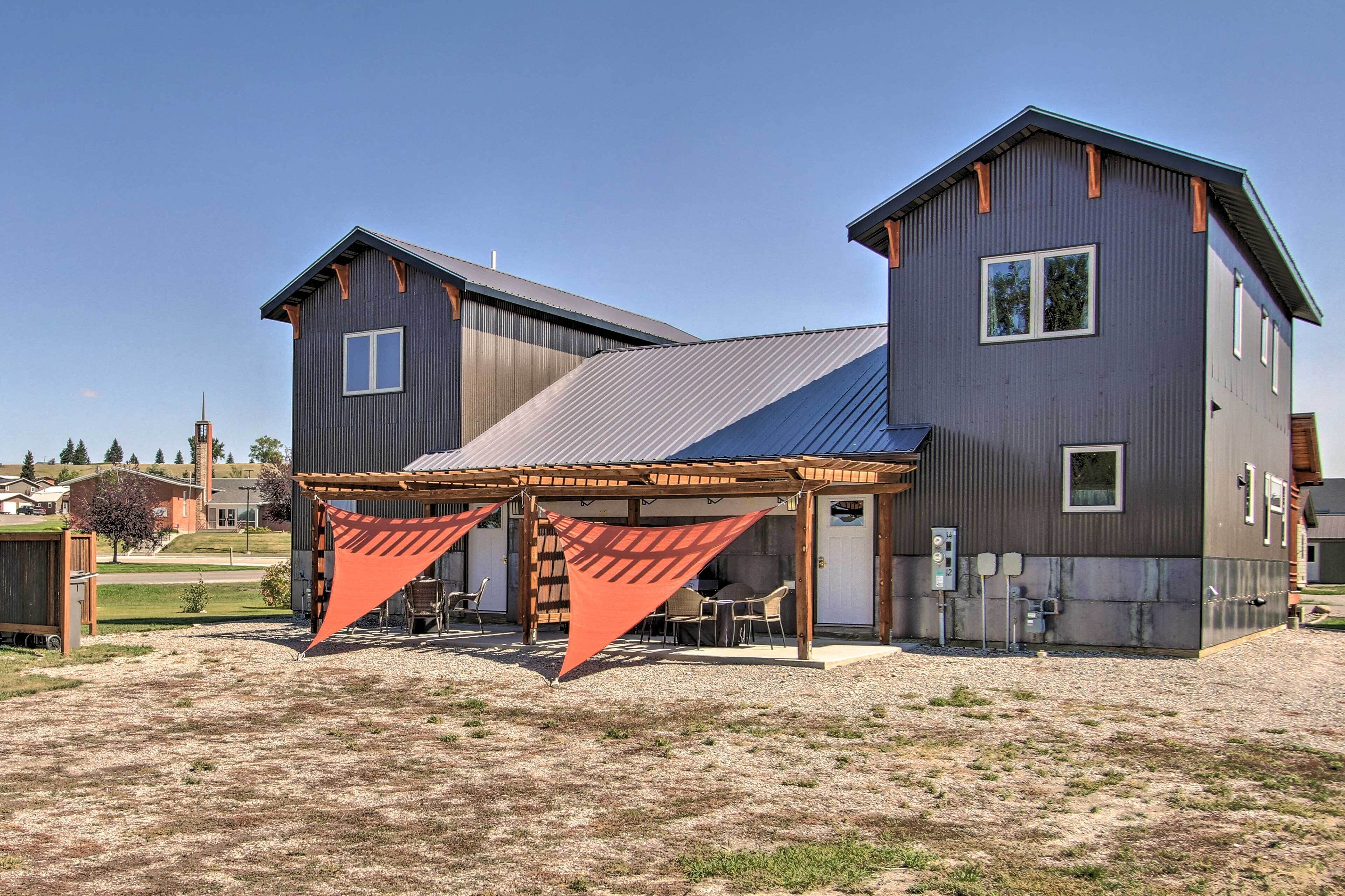 A two-story building with a covered patio area.