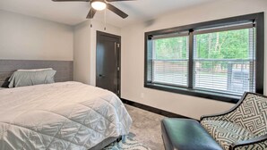 A bedroom with a bed, a ceiling fan, a window with blinds, and a door. - 5 Mi to Mercedes-benz Stadium: Stylish ATL Retreat (Atlanta)